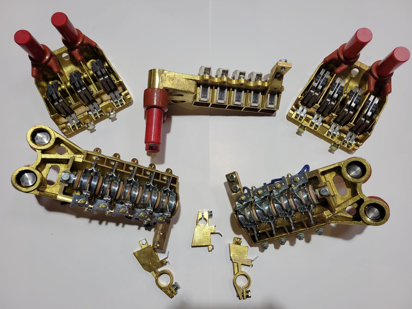 Rebuilt locomotive brush holders with red insulators and spring assemblies